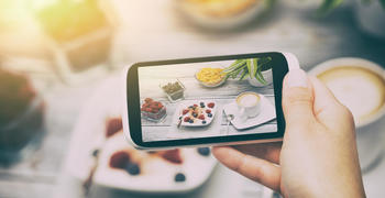 a close up of a person holding a plate of food