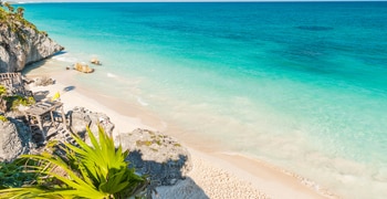 a sandy beach next to the ocean