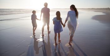 a man and a woman walking on a beach