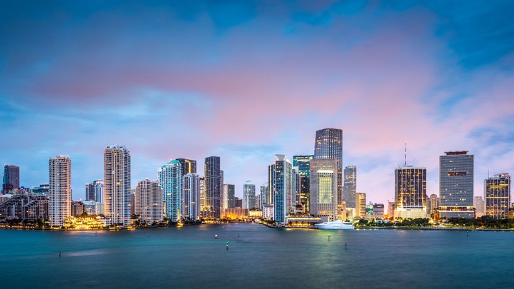 a large body of water with a city in the background