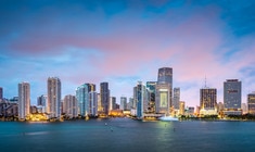 a large body of water with a city in the background