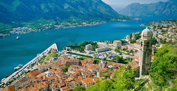 a large body of water with a mountain in the background