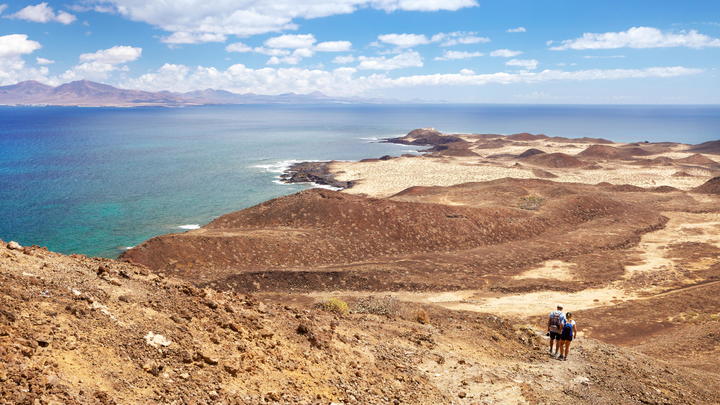 a sandy beach next to the ocean