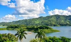 a body of water with a mountain in the background