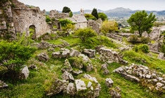 a herd of sheep grazing on a rocky hill