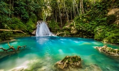 a large waterfall and a pool of water