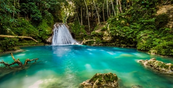 a large waterfall and a pool of water