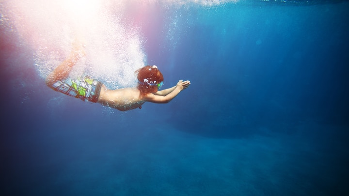 a person swimming in a body of water