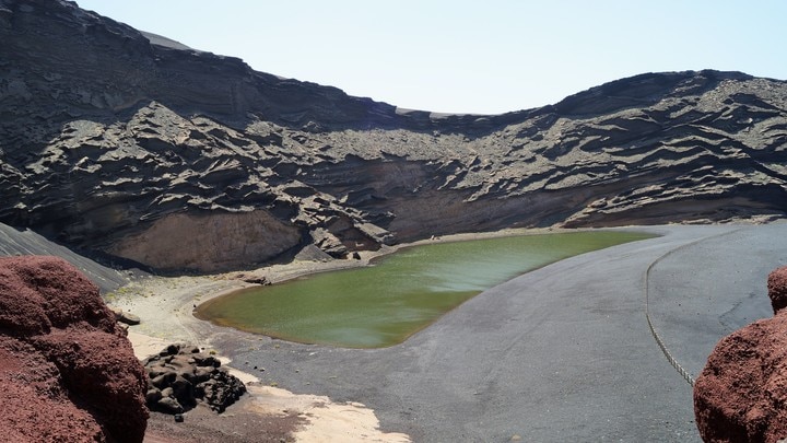 a body of water with a mountain in the background