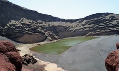 a body of water with a mountain in the background