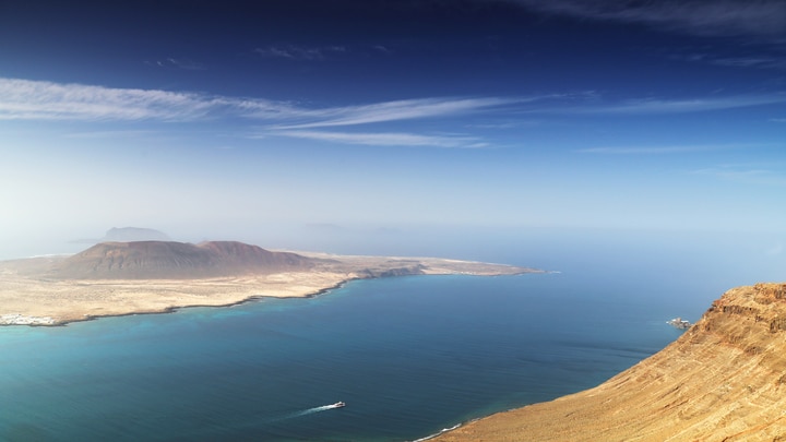 a body of water with a mountain in the background