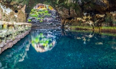 a large waterfall over a body of water