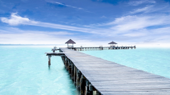 a wooden pier next to a body of water