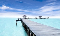 a wooden pier next to a body of water