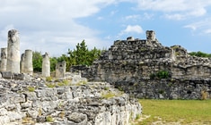 a stone castle next to a rock