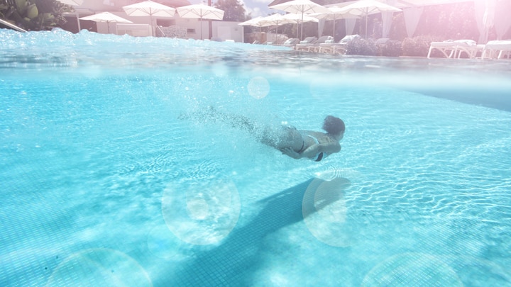 a man swimming in a pool of water