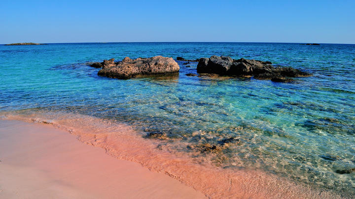 a rocky beach next to a body of water