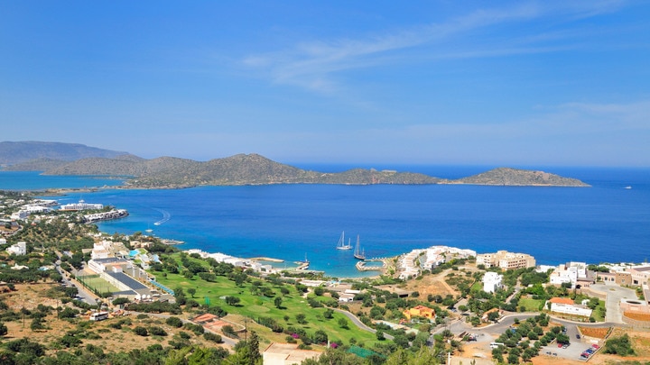 a large body of water with a mountain in the background