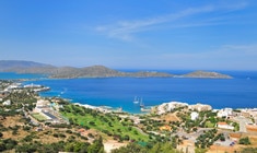 a large body of water with a mountain in the background