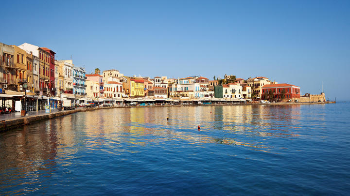 a small boat in a harbor next to a body of water