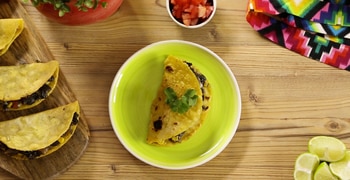 a plate of food sitting on top of a wooden table