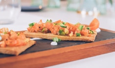 a plate of food sitting on top of a wooden cutting board