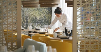 a group of people standing around a table