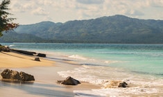 a body of water with a mountain in the background