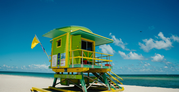 a small yellow house on a beach
