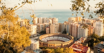 a city with a body of water in the background